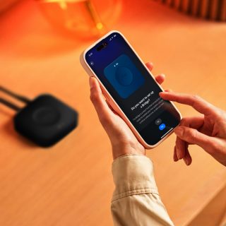 A close-up of somebody using the Hue app to install the Bridge Pro.