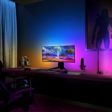 Single-monitor PC gaming setup and colourful smart lights surrounding it