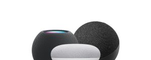 A collection of compact, spherical smart speakers in black and white with mesh fabric finish and visible top surface features.