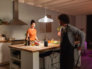 Couple in kitchen using bluethooth alexa and hue
