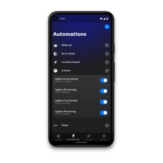 Smart lighting app Automations screen showing toggles for wake up, sleep, location, and custom routines with lights scheduling options.